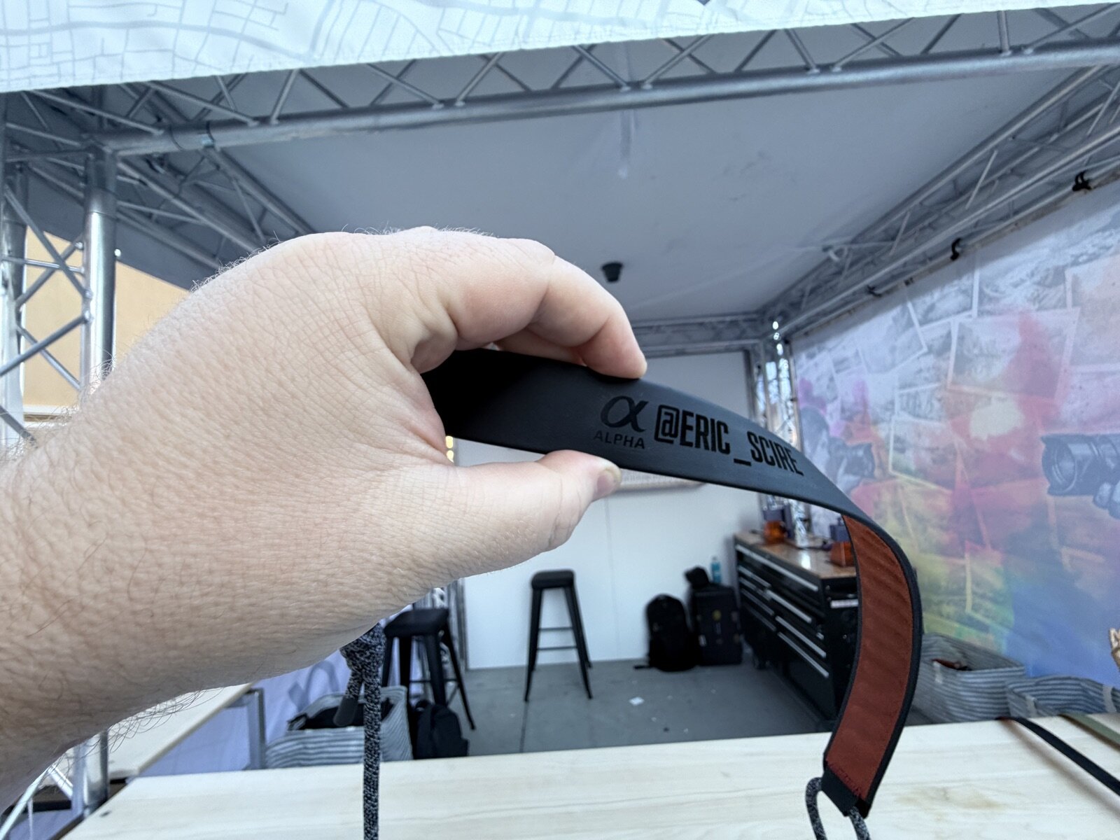 Camera strap personalized with a guest's handle at an outdoor brand activation booth